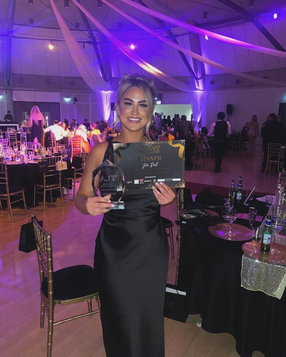 Jade Peel at The Leading Aesthetics Awards with her winner certificate and trophy